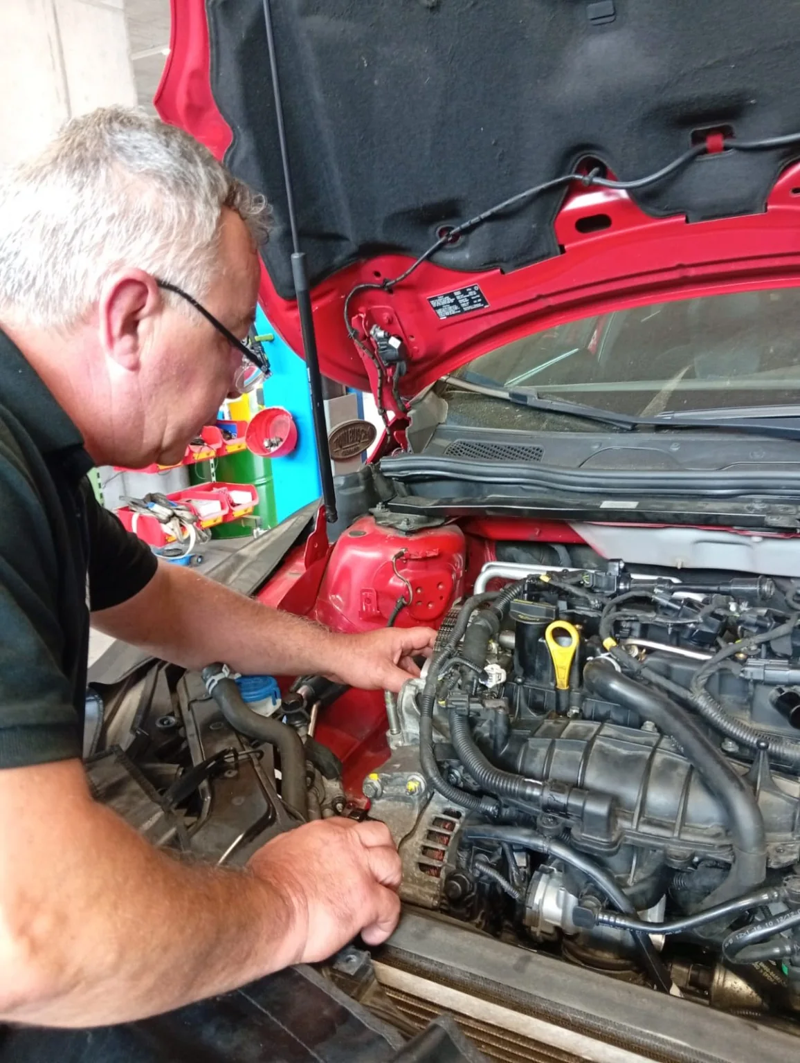 Zwei Mechaniker arbeiten an einem ausgebauten Fahrzeugmotor